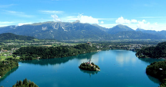 Landscape shot of a lake with an island and mountains in the background
